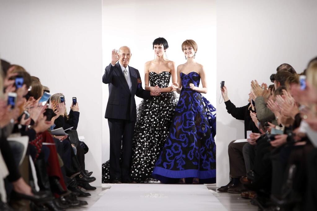 FILE - In this Feb. 11, 2014 file photo, Designer Oscar de la Renta acknowledges the audience after his Fall 2014 collection show during Fashion Week in New York. The designer de la Renta, a favorite of socialites and movie stars alike, has died. He was 82. (AP Photo/Jason DeCrow, File)
