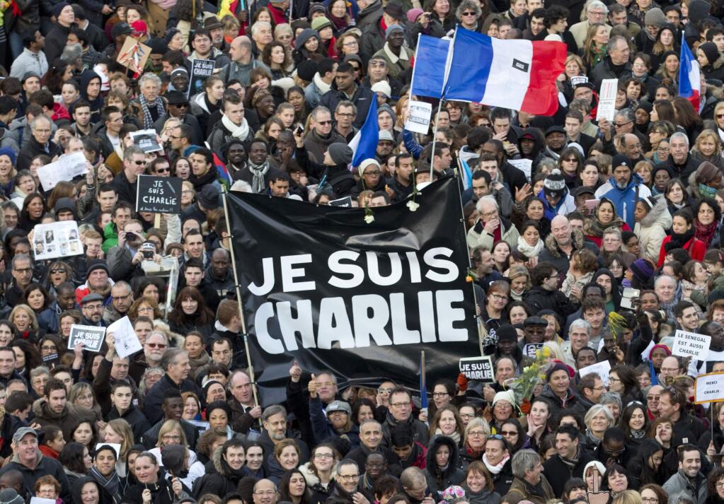 Thousands of people gather at Republique square in Paris, France, Sunday, Jan. 11, 2015. Thousands of people began filling Frances iconic Republique plaza, and world leaders converged on Paris in a rally of defiance and sorrow on Sunday to honor the 17 victims of three days of bloodshed that left France on alert for more violence. (AP Photo/Peter Dejong)