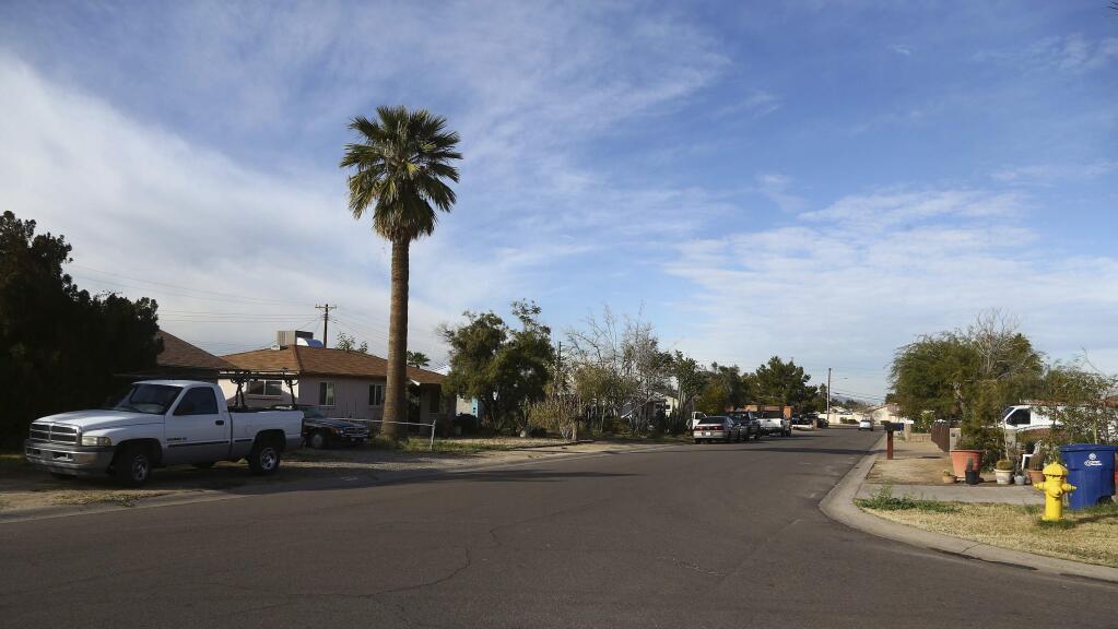 This photo shows part of South Fair Lane in Tempe, Ariz., Thursday, Jan. 17, 2019. Police in the Phoenix suburb say a burglary suspect shot to death by an officer was a 14-year-old boy carrying a replica gun. (AP Photo/Ross D. Franklin)