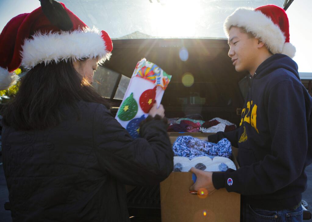 Petaluma, CA, USA. Friday, December 16, 2016._ Debbie Yee and her son, David, 18, are volunteers with Christmas Cheer. They've been helping deliver boxes of donations to needy folks in Petaluma for years. (CRISSY PASCUAL/ARGUS-COURIER STAFF)