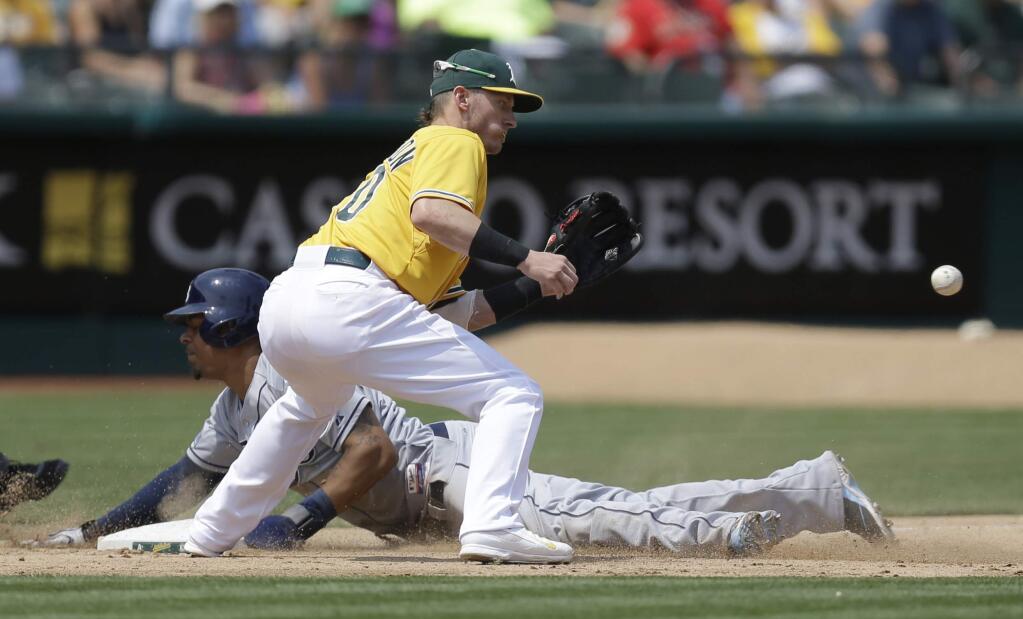 Tampa Bay Rays' Desmond Jennings slides while advancing to third base as Oakland Athletics' Josh Donaldson waits for the ball in the fifth inning of a baseball game Wednesday, Aug. 6, 2014, in Oakland. Jennings advanced on a single hit by Ben Zobrist. (AP Photo/Ben Margot)