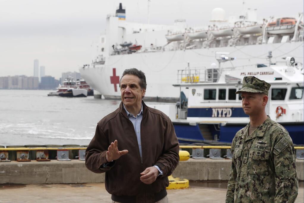 Gov. Andrew Cuomo speaks during a news conference Monday as a hospital ship arrived in New York. (KATHY WILLENS / Associated Press)