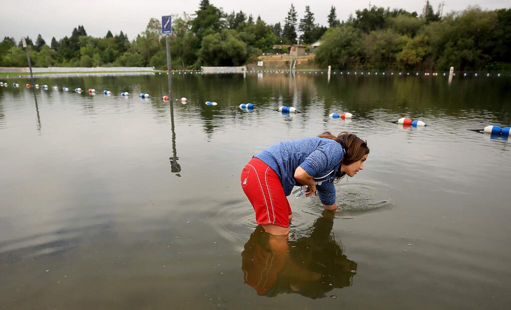 Sonoma County Environmental Health Specialist Lindsay Sergbers takes samples for blue-green algae at Healdsburg Veterans Memorial Beach on Monday, July 24, 2017. (KENT PORTER/ PD)