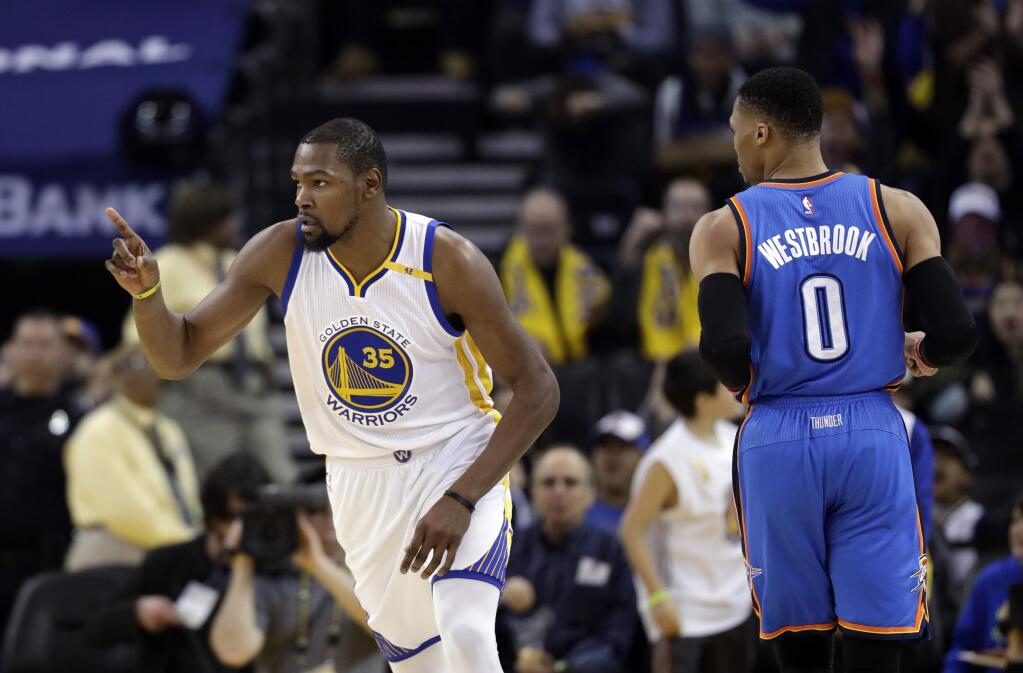 The Golden State Warriors' Kevin Durant, left, during the first half against the Oklahoma City Thunder Wednesday, Jan. 18, 2017, in Oakland. (AP Photo/Marcio Jose Sanchez)