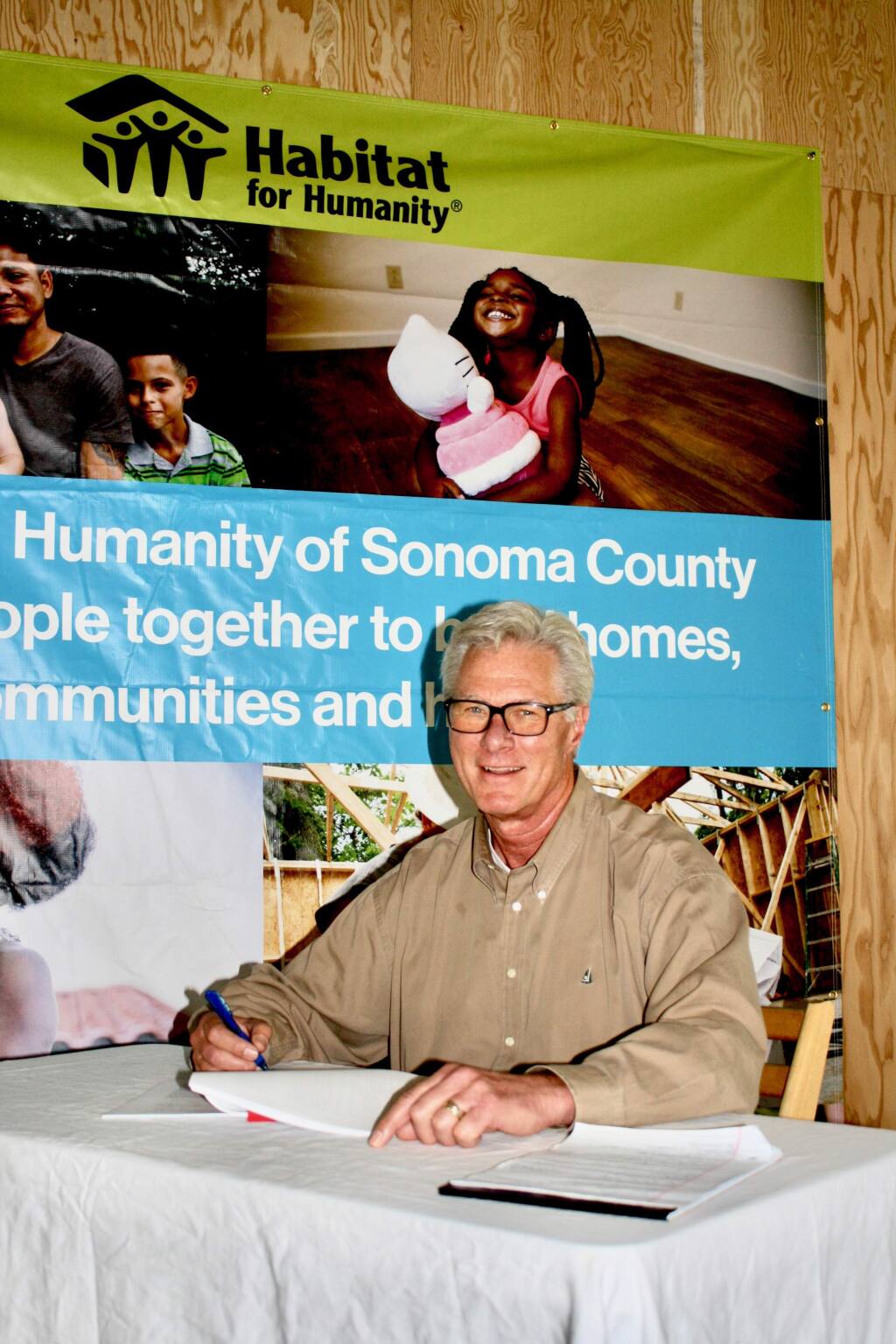 Sonoma County Habitat for Humanity Chairman Tim Leach on Thursday, May 23, 2019, signs the lease for 65,000 square feet of indoor and outdoor manufacturing and storage space at SOMO Village in Rohnert Park. (Gary Quackenbush / for North Bay Business Journal)