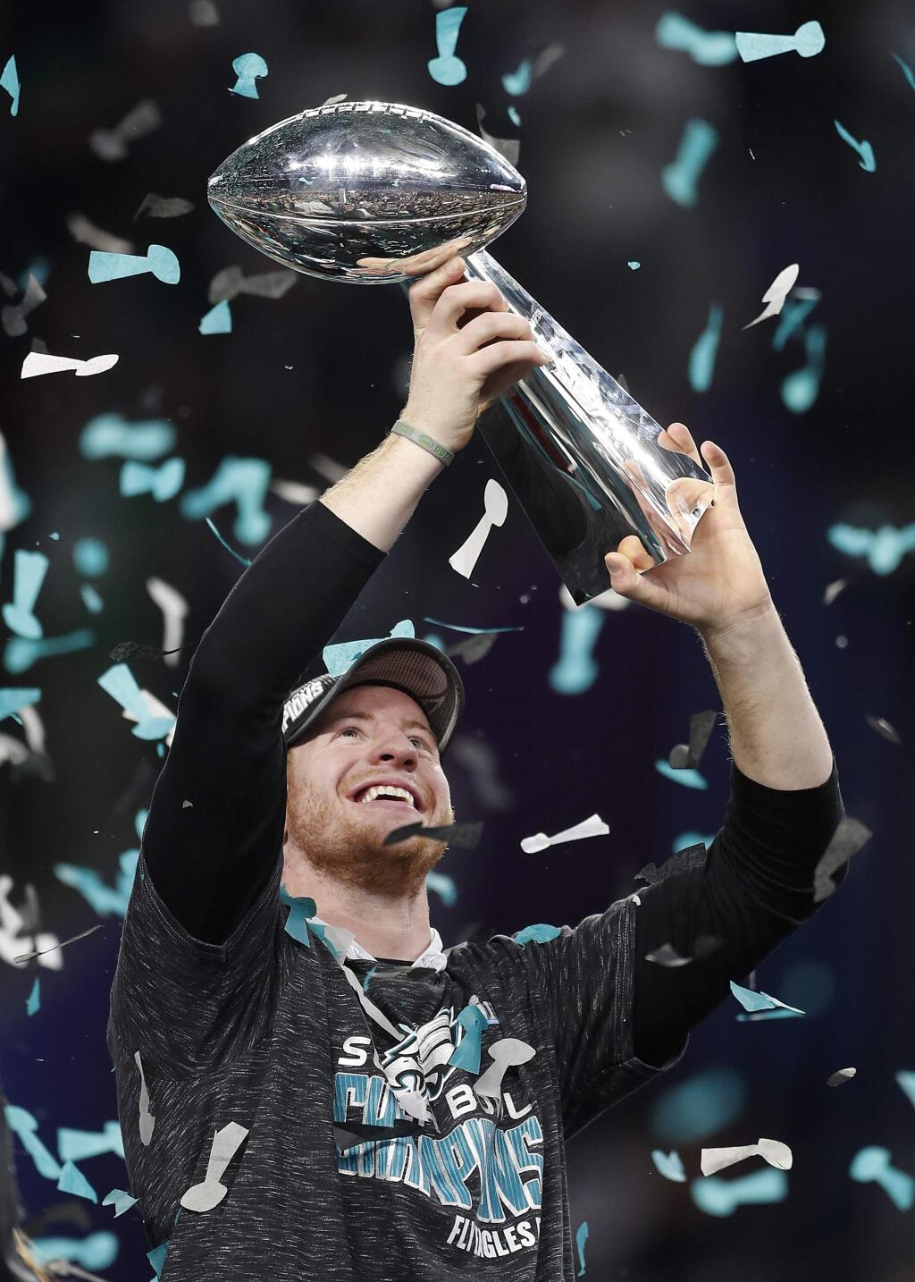 Philadelphia Eagles' Carson Wentz holds up the Vince Lombardi Trophy after the NFL Super Bowl 52 football game against the New England Patriots, Sunday, Feb. 4, 2018, in Minneapolis. The Eagles won 41-33. (AP Photo/Jeff Roberson)