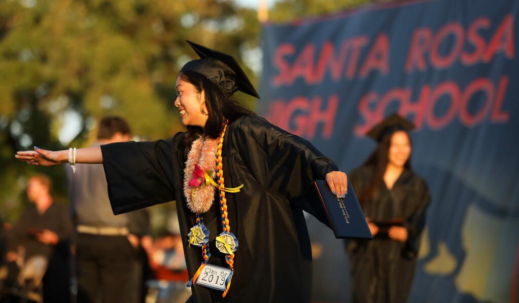 Akari Yu celebrates after receiving her diploma at the Santa Rosa High School graduation on Friday night. (John Burgess/The Press Democrat)
