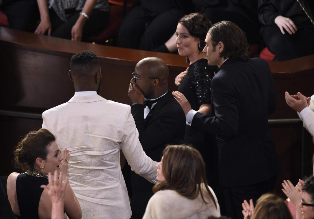 Barry Jenkins reacts as 'Moonlight' is announced as the true winner of best picture at the Oscars on Sunday, Feb. 26, 2017, at the Dolby Theatre in Los Angeles. It was originally announced mistakenly that 'La La Land' was the winner. (Photo by Chris Pizzello/Invision/AP)