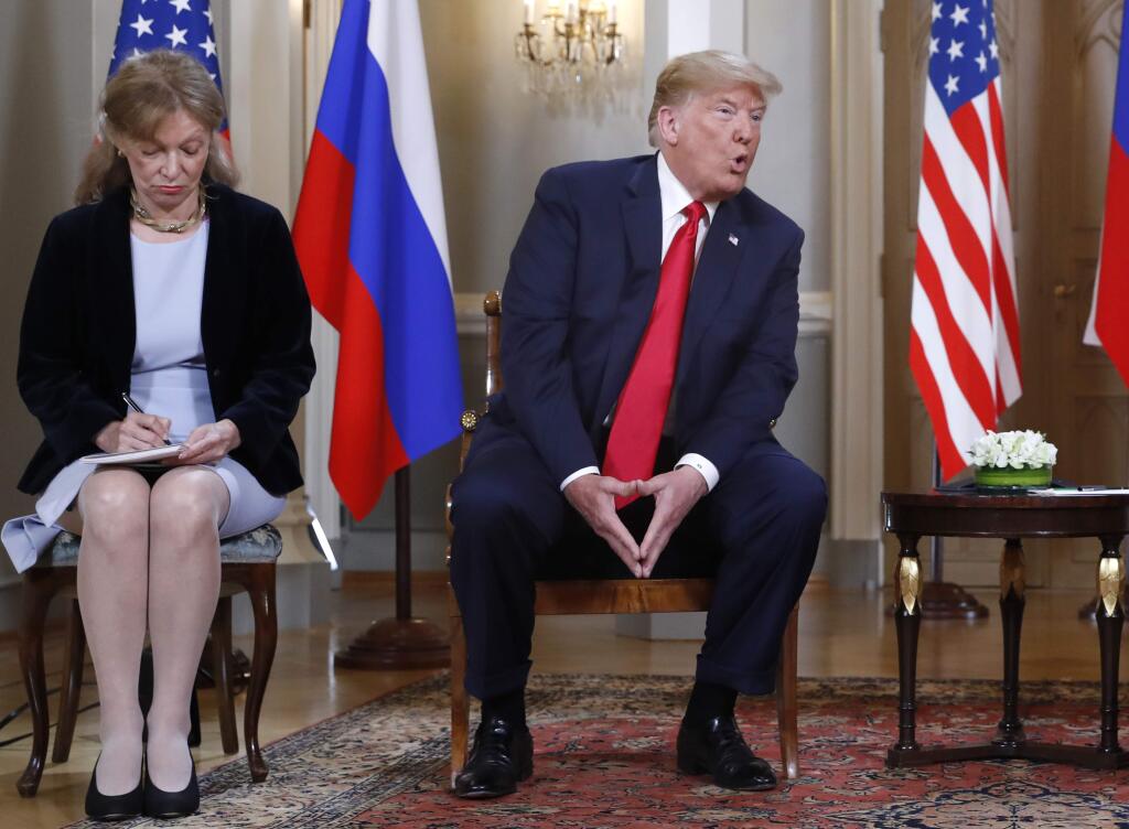 In this July 16, 2018 file photo interpreter Marina Gross, left, takes notes when U.S. President Donald Trump talks to Russian President Vladimir Putin at the beginning of their one-on-one-meeting at the Presidential Palace in Helsinki, Finland, Monday, July 16, 2018. (AP Photo/Pablo Martinez Monsivais)
