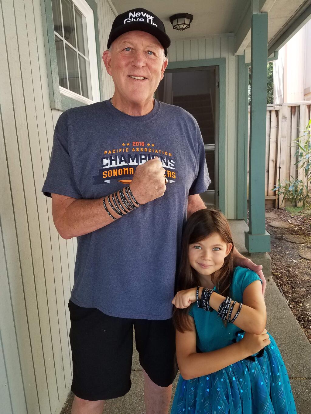 Taylor, shown here with local student Alessandra Lupo, sporting their 'Never Give Up' wristbands.