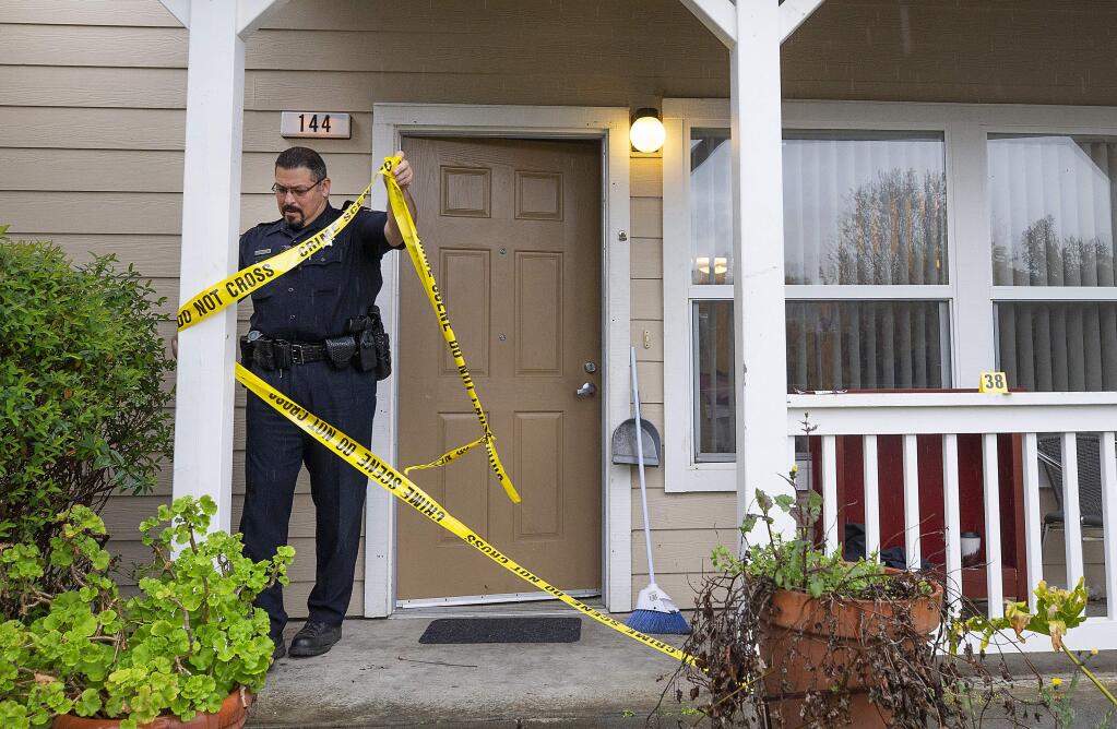 Healdsburg Police Department Sgt. Nick Castaneda removes crime scene tape from a Canyon Run Apartments unit where an 18-year-old man fatally stabbed another man on Wednesday, March 28, 2019. (JOHN BURGESS/ PD)