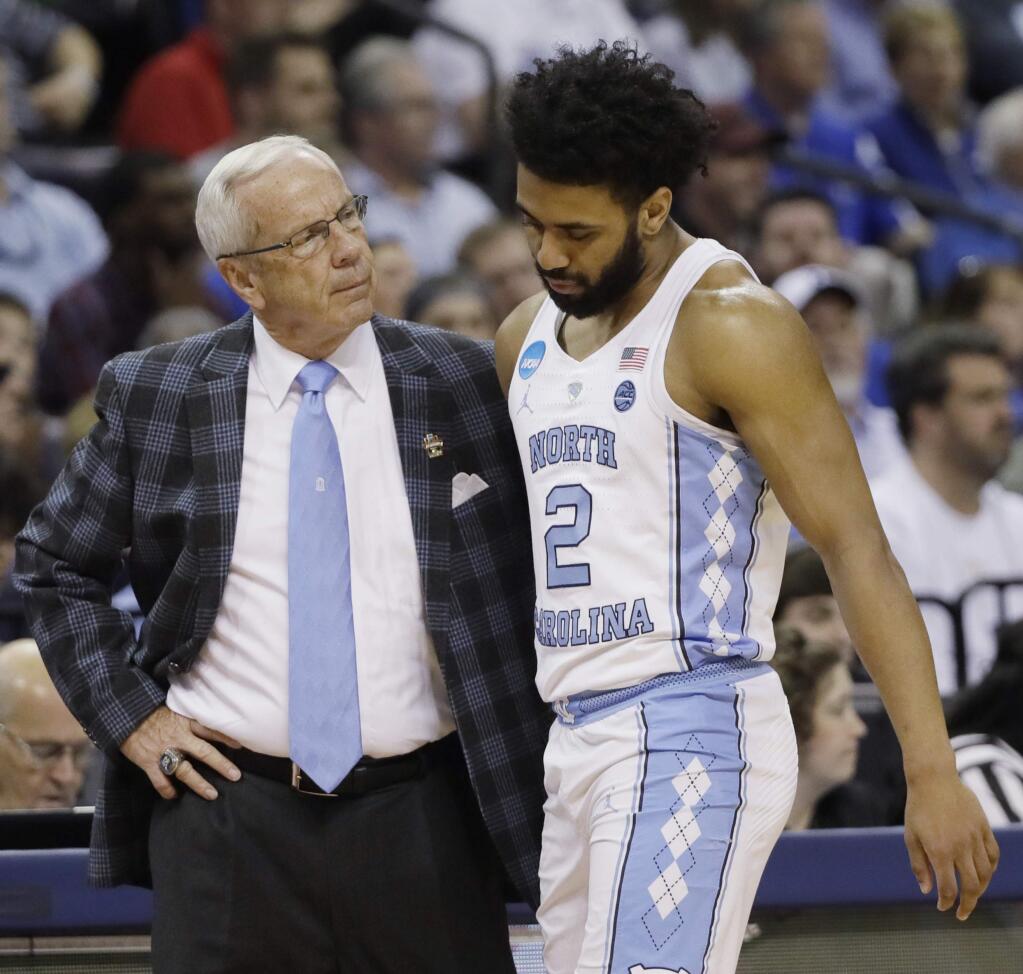 North Carolina head coach Roy Williams speaks with North Carolina guard Joel Berry II (2) in the first half of the South Regional final game in the NCAA college basketball tournament against Kentucky, Sunday, March 26, 2017, in Memphis, Tenn. (AP Photo/Mark Humphrey)