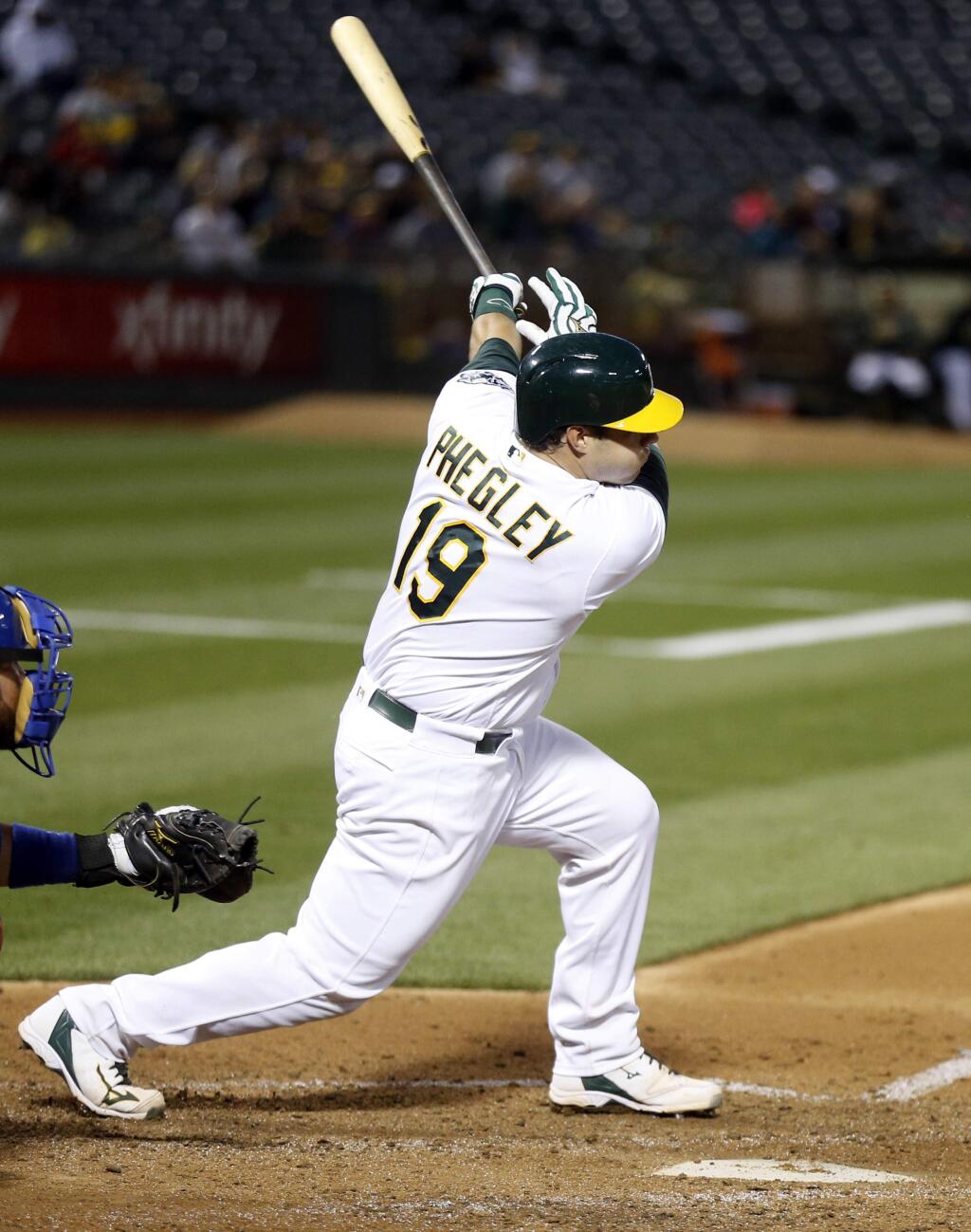 Oakland Athletics' Josh Phegley follows through on a three-run home run against the Texas Rangers during the fourth inning of a baseball game Monday, June 13, 2016, in Oakland, Calif. (AP Photo/D. Ross Cameron)
