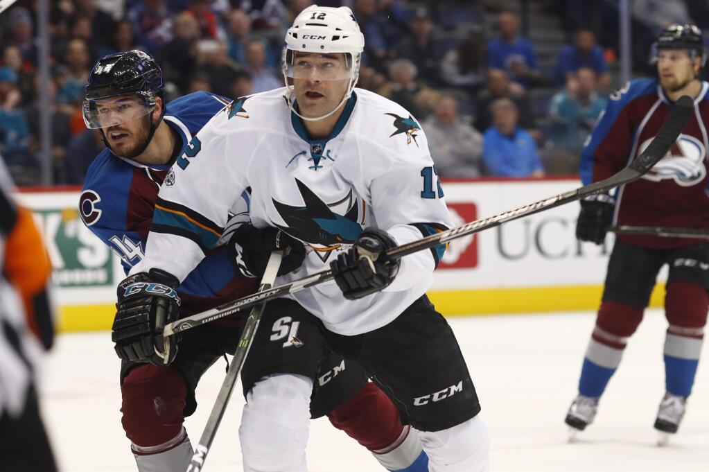 San Jose Sharks left wing Patrick Marleau, right, follows the puck as it flies toward the net as Colorado Avalanche defenseman Eric Gelinas defends in the second period of an NHL hockey game, Monday, Jan. 23, 2017, in Denver. (AP Photo/David Zalubowski)