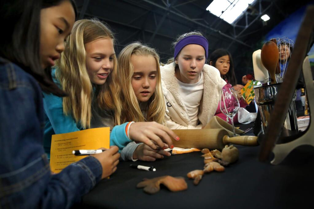 (From left) Students from Santa Rosa Accelerated Charter including Amei Cibulka, 10, Addie Brandt, 10, Alyssa Boyd, 11, and Grace Wright, 11, check out the SRJC Culinary Program booth at Santa Rosa City Schools College & Career Day at the Hall of Flowers on the Sonoma County Fairgrounds on Thursday, March 12, 2015. (BETH SCHLANKER/ The Press Democrat)