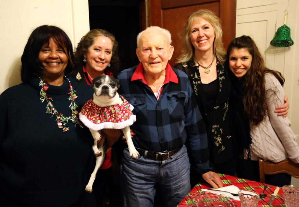PHOTO: 1 by Crista Jeremiason / The Press Democrat-SURROUNDED BY FRIENDS: A “Monday Supper Club” on Dec. 22 included, from left, Marsha Simmonsia (holding Mitzvah), Mary Pat Rowan, Walter Murray, Gina Riner and Amarica Rafanelli.
