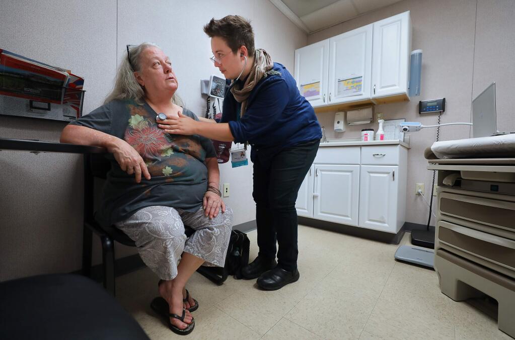 Family nurse practitioner Jennifer Herman, right, examines Pathena Byerley at the Russian River Health Center in Guerneville on Thursday, August 22, 2019. (Christopher Chung/ The Press Democrat)