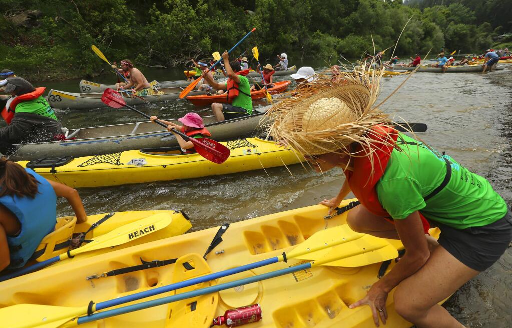 Participants launch their canoes and kayaks for the start of The Great Russian River race at Oddfellows beach in Guerneville on Saturday morning, June 4, 2016. (JOHN BURGESS/The Press Democrat)