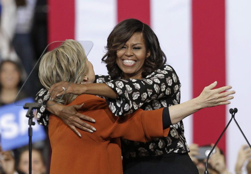 Democratic presidential candidate Hillary Clinton and first lady Michelle Obama hug during a campaign rally in Winston-Salem, N.C., Thursday, Oct. 27, 2016. (AP Photo/Chuck Burton)