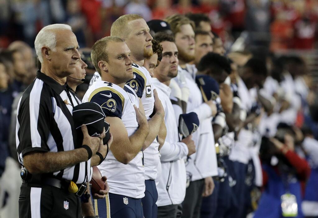 Los Angeles Rams players stand during the national anthem before an NFL football game against the San Francisco 49ers in Santa Clara, Calif., Monday, Sept. 12, 2016. (AP Photo/Jeff Chiu)