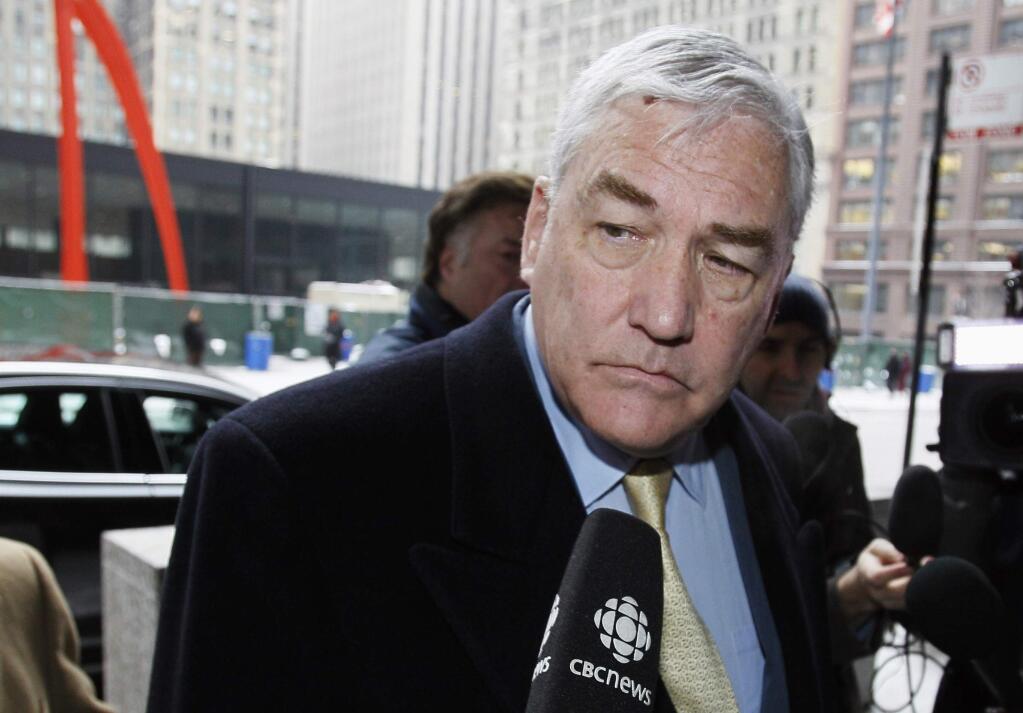 FILE - In this Jan. 13, 2011 file photo, Conrad Black arrives at the federal building in Chicago. President Donald Trump has granted a full pardon to Black, a former newspaper publisher who has written a flattering political biography of Trump. Black's media empire once included the Chicago Sun-Times and The Daily Telegraph of London. (AP Photo/Charles Rex Arbogast, File)