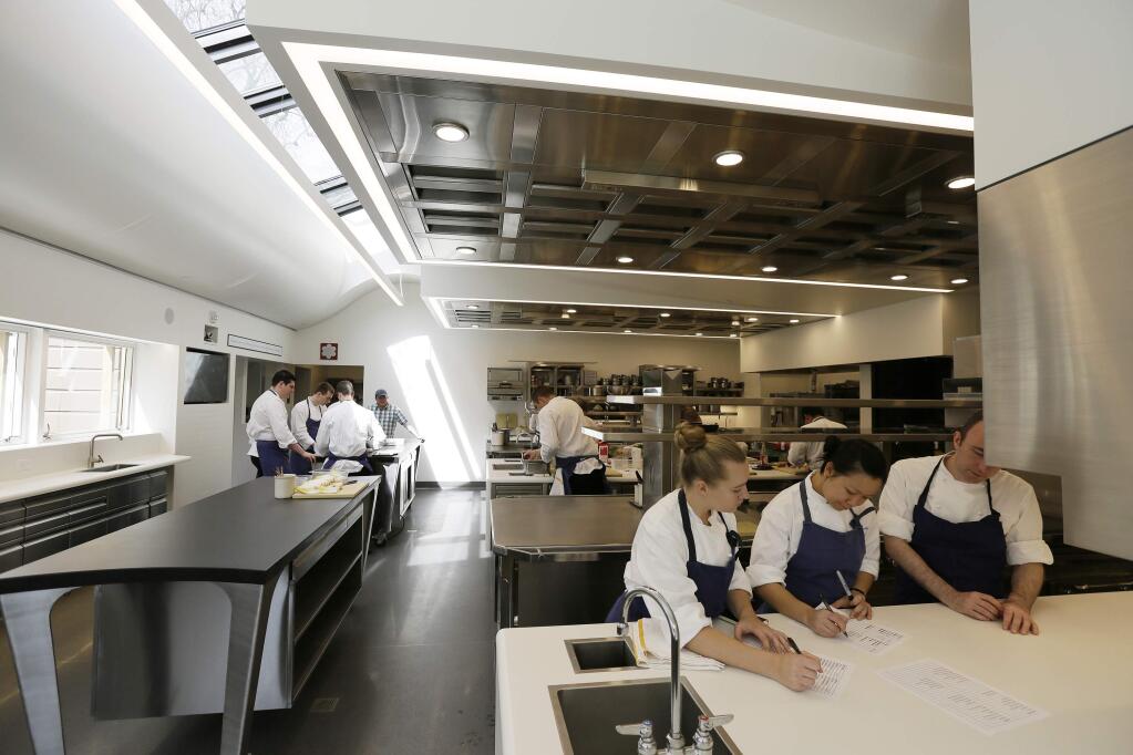 In this photo taken Thursday, March 9, 2017, part of the team at the French Laundry restaurant make preparations in the kitchen for dinner service in Yountville, Calif. Celebrated chef Thomas Keller has just opened a state-of-the art new kitchen at his famed French Laundry after spending $10 million on an extensive renovation. (AP Photo/Eric Risberg)