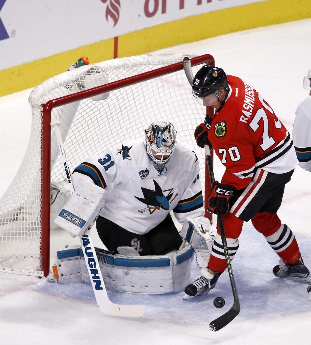 Chicago Blackhawks left wing Dennis Rasmussen (70) is unable to get a shot on San Jose Sharks goalie Martin Jones during the first period of an NHL hockey game Tuesday, Feb. 9, 2016, in Chicago. (AP Photo/Charles Rex Arbogast)