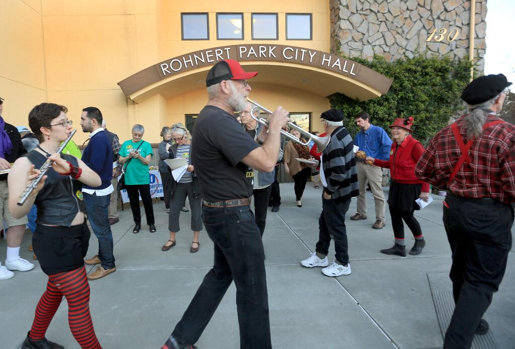During a small protest outside the Rohnert Park City Hall, Tuesday Jan. 13, 2015, the Hubbub Club band march in line as they help protest against a possible yes decision from the city council on the expansion of Wal-Mart in Rohnert Park. (Kent Porter / Press Democrat) 2015