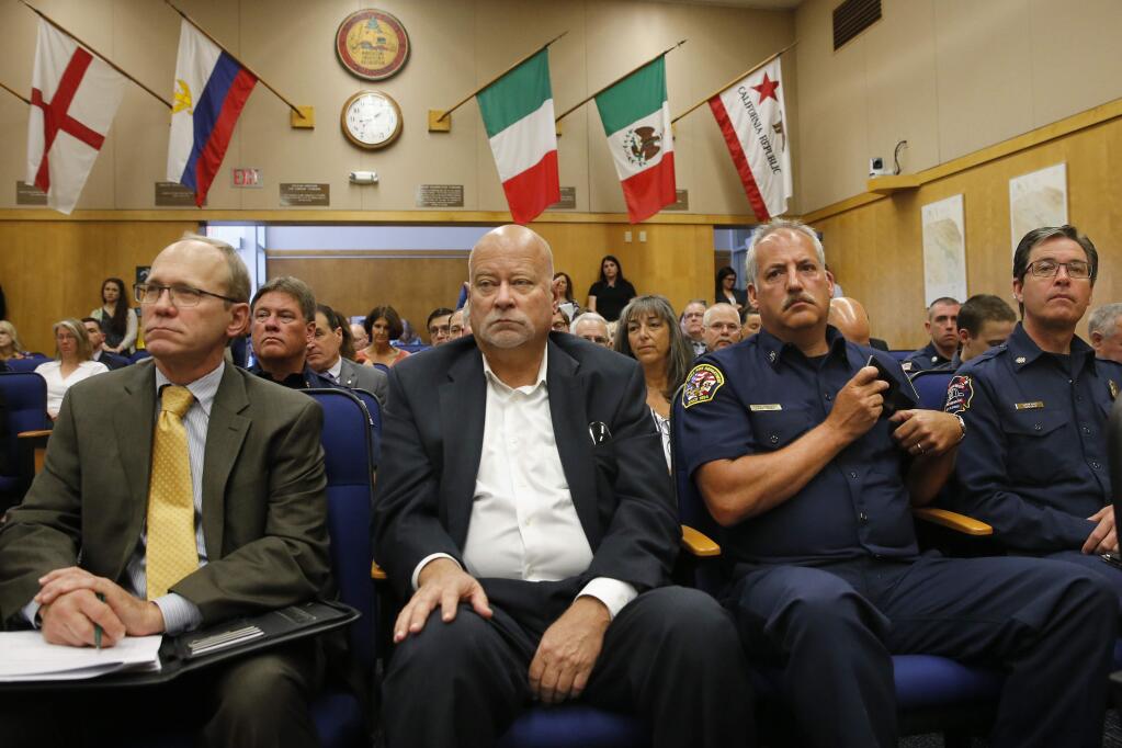 Christopher Godley, from left, Sonoma County's emergency manager, Jim Colangelo, director of the Sonoma County Fire and Emergency Services Department, Santa Rosa Fire Chief Tony Gossner, and Steve Akre, Fire Chief for Sonoma Valley Fire & Rescue Authority, attend a Sonoma County Board of Supervisors meeting in June. (Beth Schlanker/ The Press Democrat)