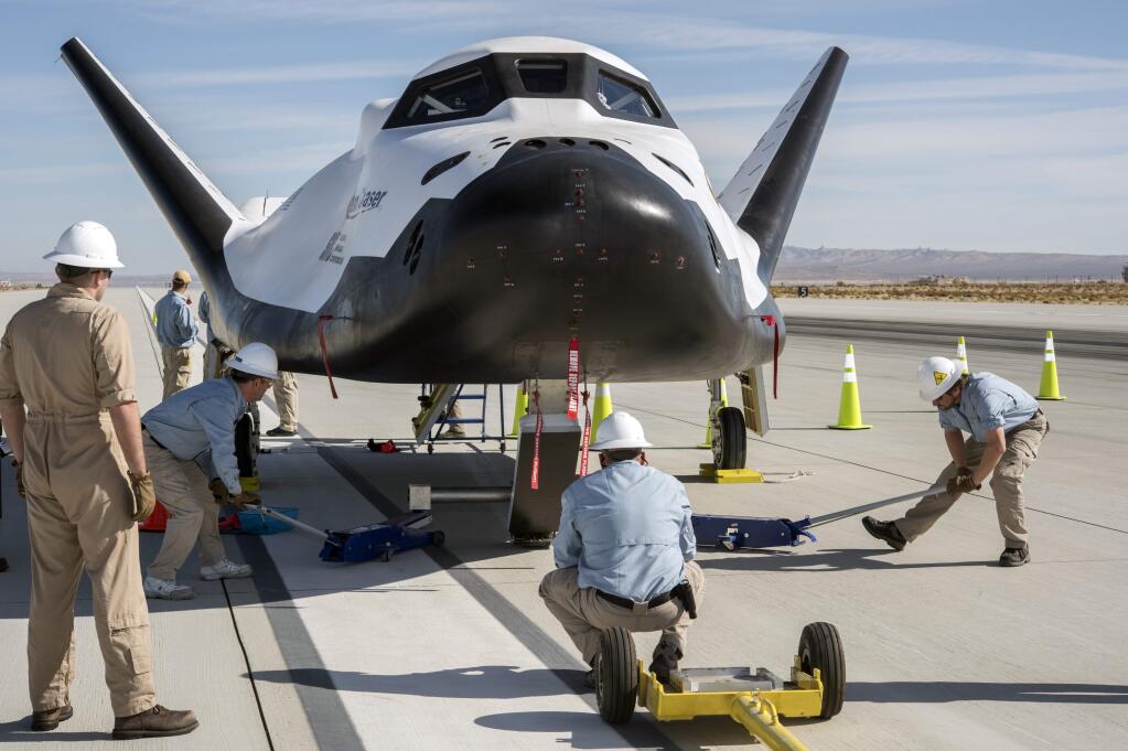 This Nov. 11, 2017 photo provided by Sierra Nevada Corporation shows the Dream Chaser crew secures the spacecraft after a successful test flight at Edwards Air Force Base, Calif. The Sierra Nevada Corp. says its Dream Chaser had a successful free-flight drop test in the Mojave Desert on Saturday, Nov. 11, 2017. (Ken Ulbrich/NASA via AP)