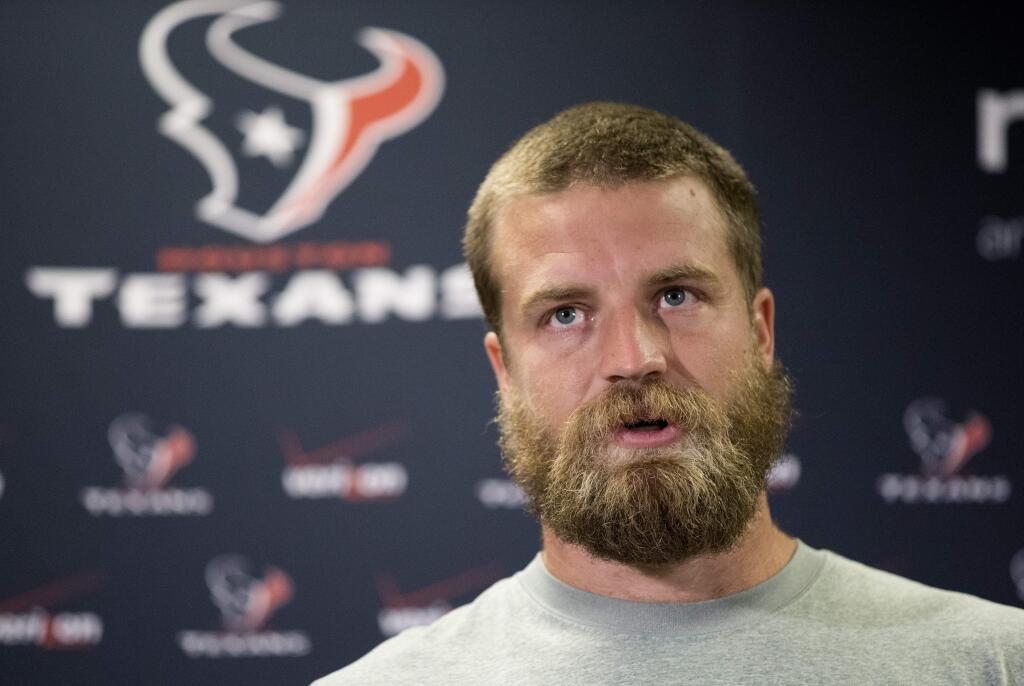 Houston Texans quarterback Ryan Fitzpatrick answers a question after reporting for NFL football training camp Friday, July 25, 2014, in Houston. The Texans begin practices Saturday. (AP Photo/David J. Phillip)