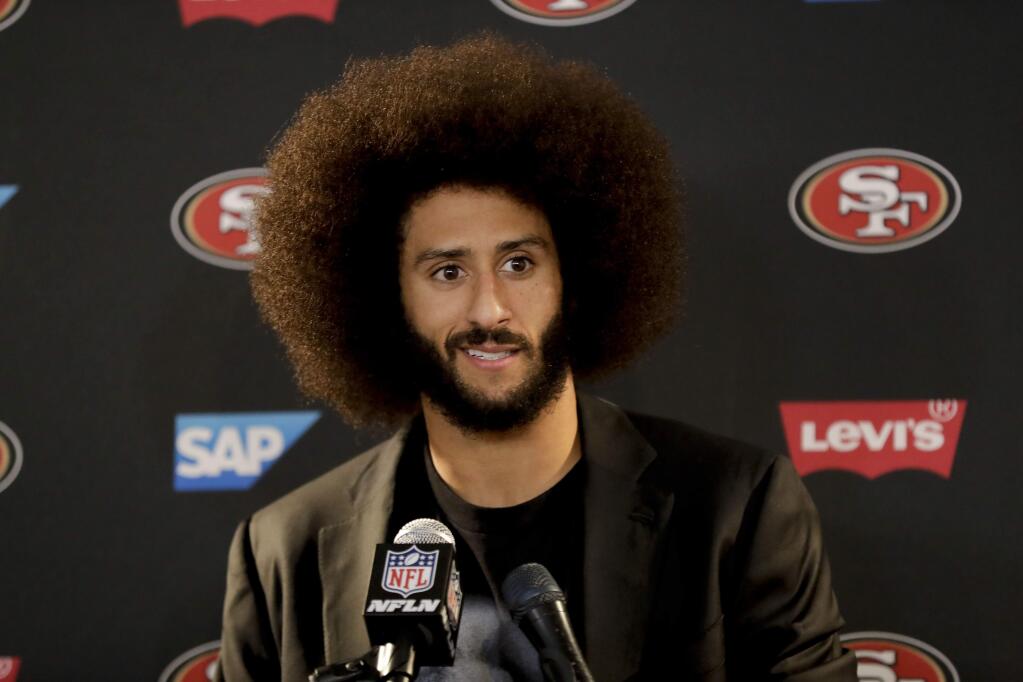 This Dec. 24, 2016 photo shows San Francisco 49ers quarterback Colin Kaepernick talking during a news conference after an NFL football game against the Los Angeles Rams. (AP Photo/Rick Scuteri)