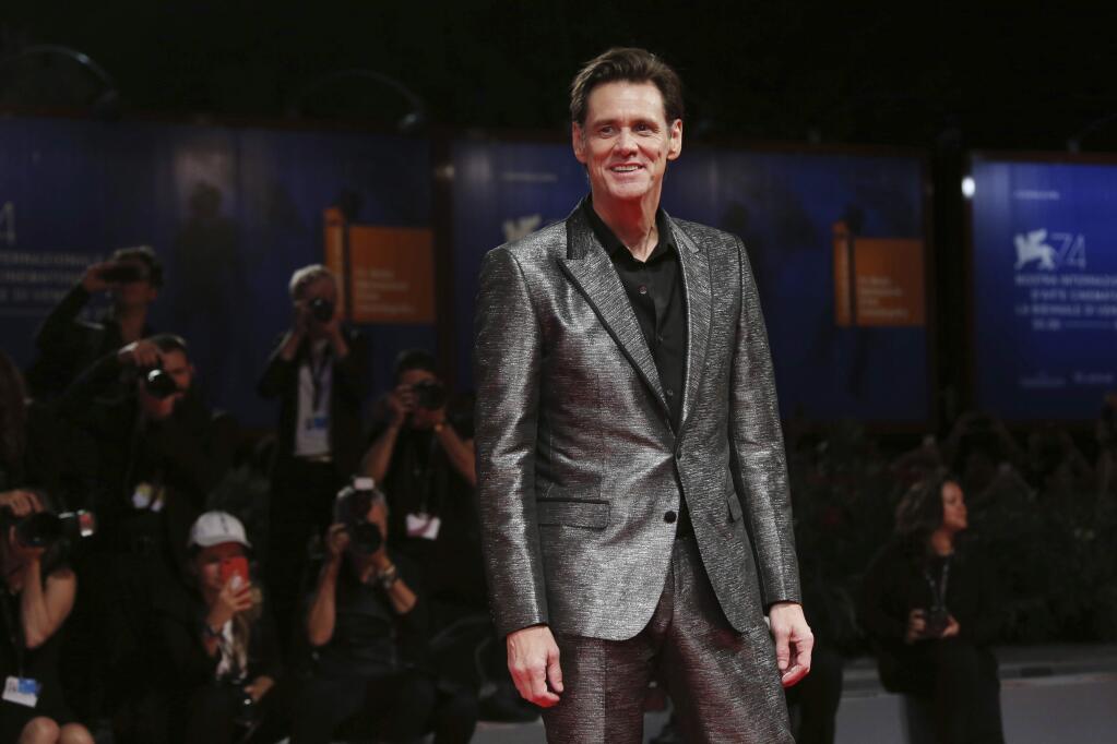 FILE - In this Sept. 5, 2017, file photo, actor Jim Carrey poses for photographers at the premiere of the film 'Jim and Andy: The Great Beyond' at the 74th edition of the Venice Film Festival in Venice, Italy. Carrey is being criticized on social media for a portrait he painted and tweeted Saturday, March 17, 2018, that is believed to be White House Press Secretary Sarah Huckabee Sanders. (Photo by Joel Ryan/Invision/AP, File)