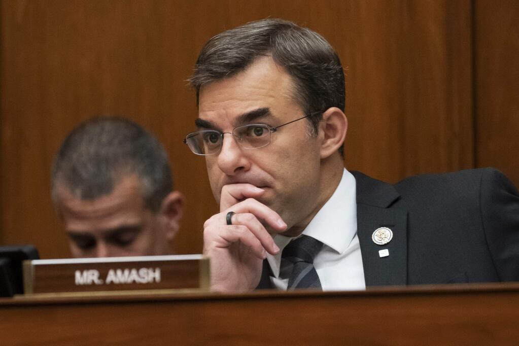 FILE - In this June 12, 2019, file photo, Rep. Justin Amash, R-Mich., listens to debate on Capitol Hill in Washington. Amash, a Trump critic, said Saturday, May 16, 2020, that he has decided not to seek the Libertarian nomination to run for president. (AP Photo/J. Scott Applewhite, File)