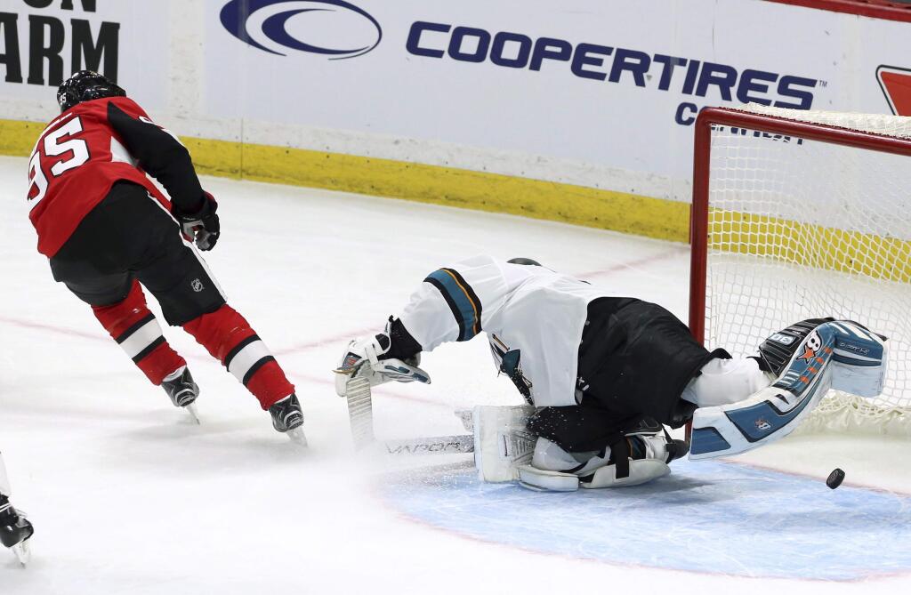 The Ottawa Senators' Matt Duchene, left, scores his goal on San Jose Sharks goaltender Aaron Dell during overtime in Ottawa, Friday, Jan. 5, 2018. (Fred Chartrand/The Canadian Press via AP)
