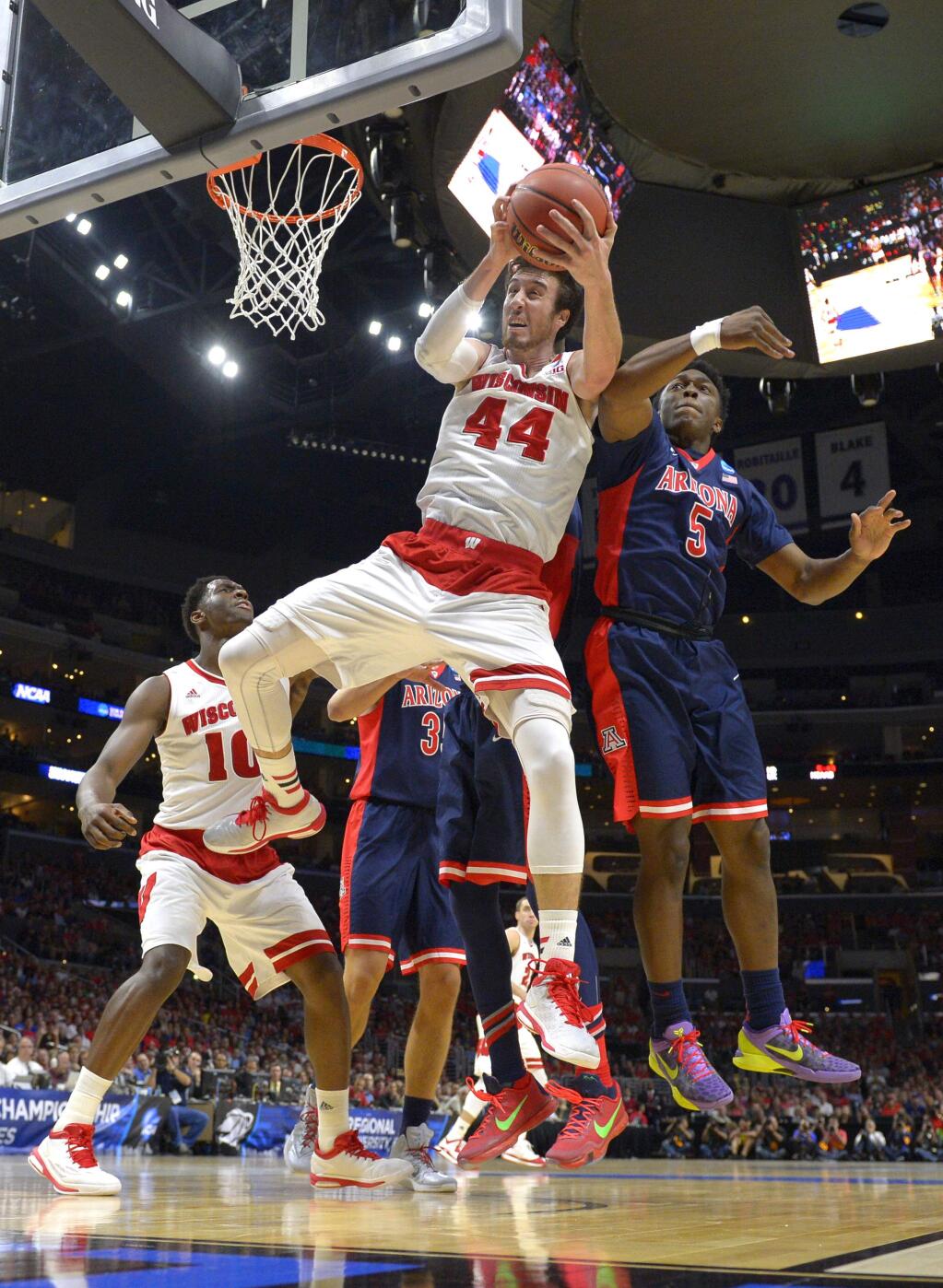 Wisconsin's Frank Kaminsky (44) grabs a rebound in front of Arizona's Stanley Johnson (5) during the first half of a region final in the NCAA tournament, Saturday, March 28, 2015, in Los Angeles. (AP Photo/Mark J. Terrill)