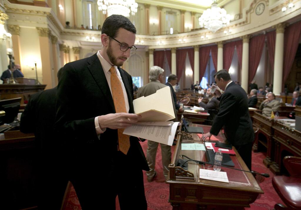 FILE - In this April 20, 2017 file photo, State Sen. Scott Wiener, D-San Francisco works at the Capitol in Sacramento, Calif. Sen. Scott Wiener has been pushing legislation to revive regulations repealed last year by the Federal Communications Commission that prevented internet companies from exercising more control over what people watch and see over the internet. (AP Photo/Rich Pedroncelli, File)