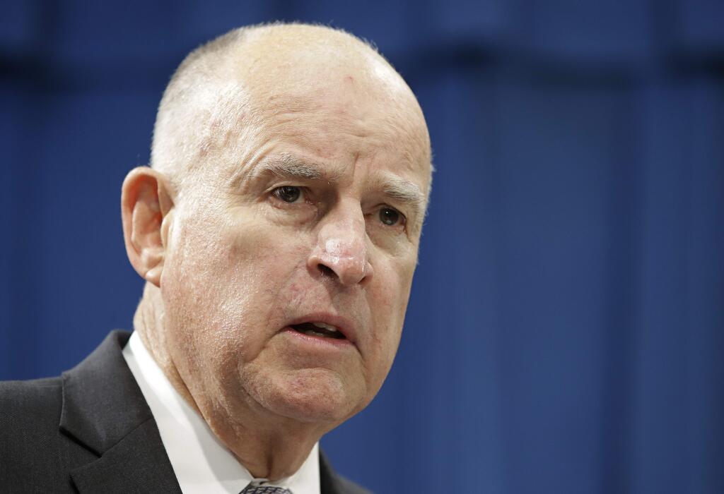 FILE - In this Jan. 10, 2018 file photo California Gov. Jerry Brown listens to a question concerning his proposed 2018-19 state budget at a news conference in Sacramento, Calif. Brown is paring down his troubled proposal for redoing California's north-south water system, in hopes of launching the mega-project before he leaves office this year. (AP Photo/Rich Pedroncelli,File)