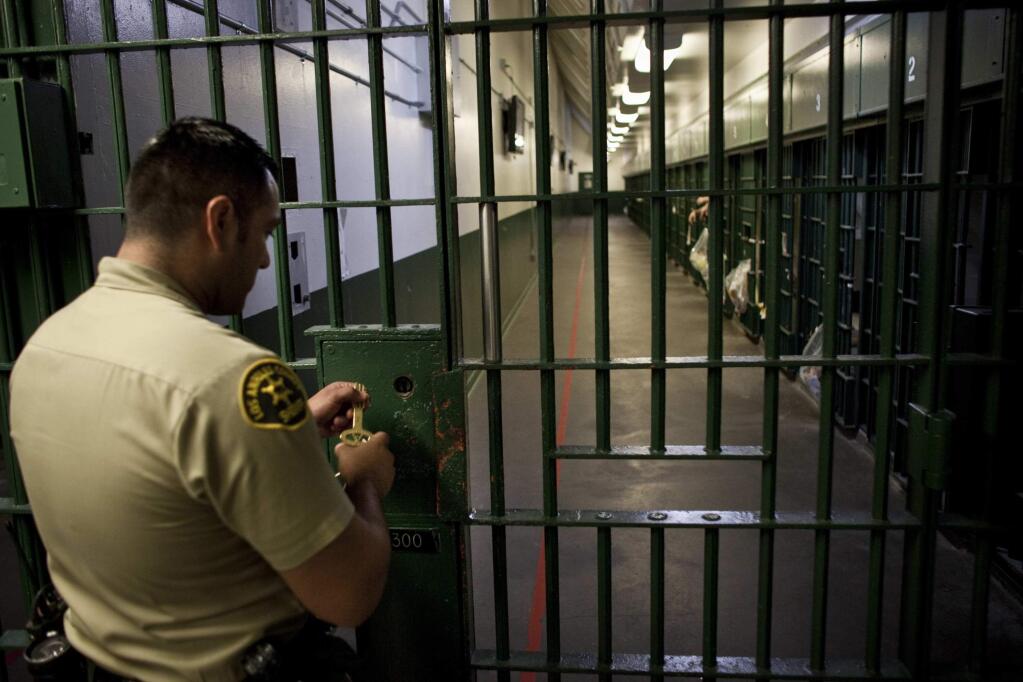 A sheriff's deputy prepares to unlock a security door to a cellblock at the Los Angeles County Men's Central Jail. (JAY L. CLENDENIN / Los Angeles Times, 2011)
