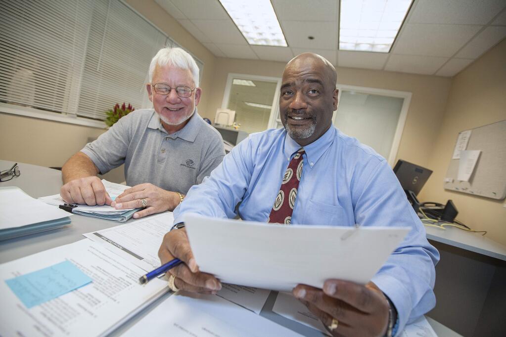 Robert Hughes, right, learns the ropes from interim CEO Alan Anspach. Hughes, a vet of Bay Area YMCAs, officially takes the reins at the Boys & Girls Clubs on June 15.