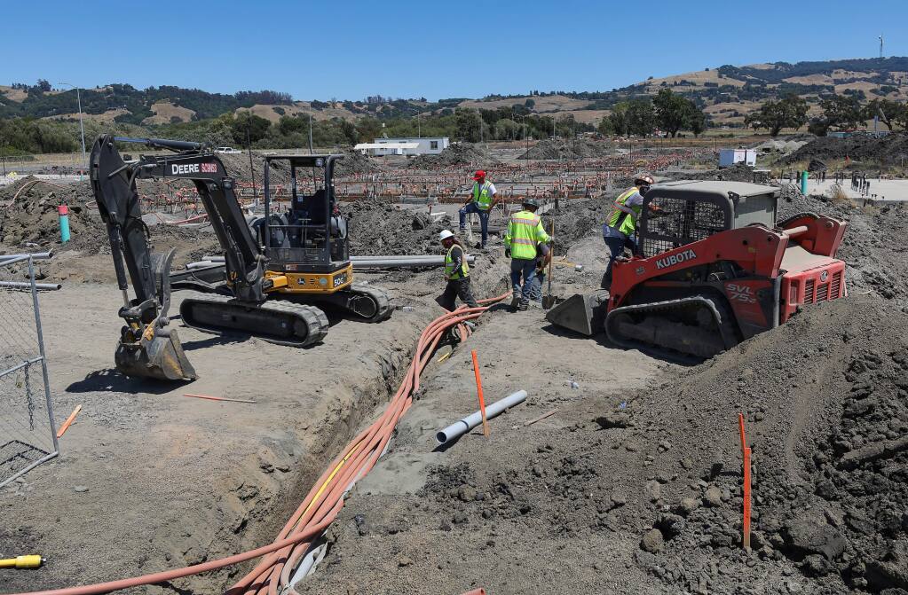 A construction crew continues work on The Parkside apartment project, which will provide affordable housing, in Rohnert Park on Friday, August 2, 2019. (Christopher Chung/ The Press Democrat)