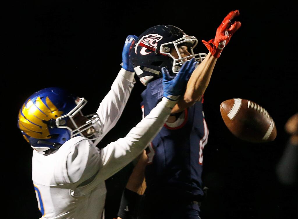 Rancho Cotate's Jack Reese (15), right, bats away a pass intended for Bakersfield Christian's Ronnie Simril (2) during the first half of the CIF Division 3-A state championship football game between Rancho Cotate and Bakersfield Christian high schools, in Rohnert Park, California, on Saturday, December 14, 2019. (Alvin Jornada / The Press Democrat)