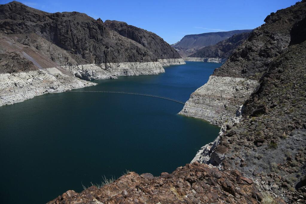 FILE - In this May 31, 2018, file photo, the low level of the water line is shown on the banks of the Colorado River in Hoover Dam, Ariz. (AP Photo/Ross D. Franklin, File)