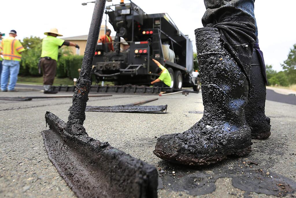 Slurry sealing on Sonoma City streets is only part of the roadwork going on in the Valley this month. (Kent Porter / Press Democrat) 2013