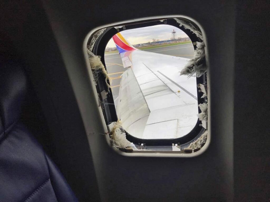 This April 17, 2018 photo provided by Marty Martinez shows the window that was shattered after a jet engine of a Southwest Airlines airplane blew out at altitude, resulting in the death of a woman who was nearly sucked from the window during the flight of the Boeing 737 bound from New York to Dallas with 149 people aboard, shown after it made an emergency landing in Philadelphia. (Marty Martinez via AP)