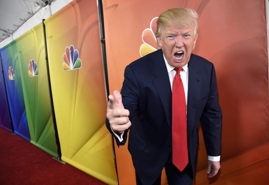 FILE - In this Jan. 16, 2015 file photo, Donald Trump, host of the television series 'The Celebrity Apprentice,' mugs for photographers at the NBC 2015 Winter TCA Press Tour in Pasadena, Calif. NBC on Monday, June 29, 2015 said that it is ending its business relationship with Trump, now a Republican presidential candidate, because of comments he made about immigrants during the announcement of his campaign. (Photo by Chris Pizzello/Invision/AP, File)