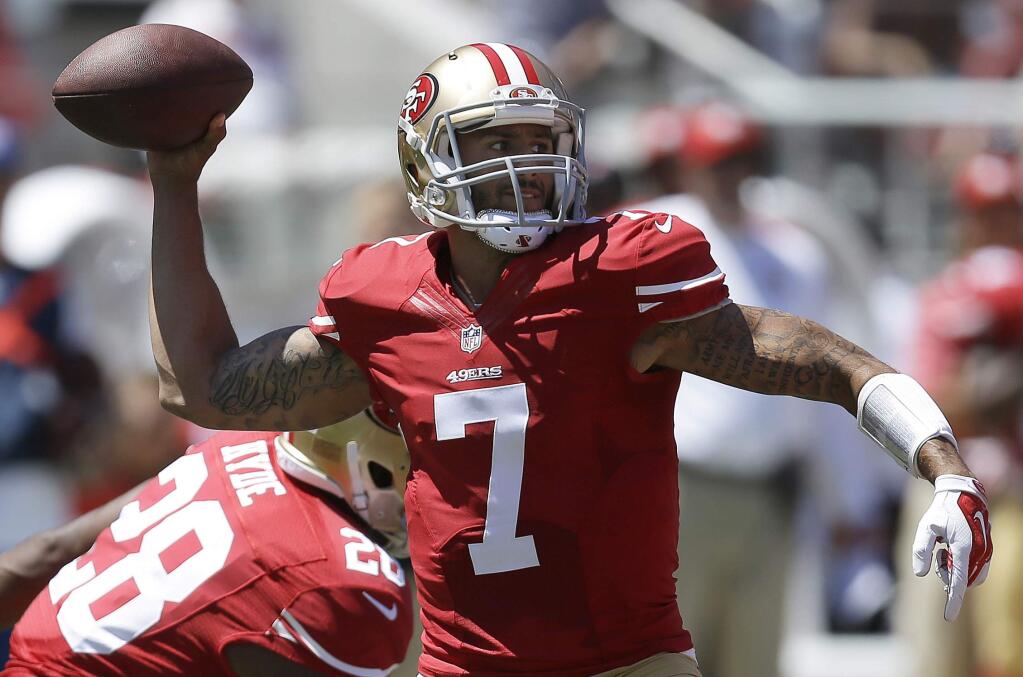 FILE - In this Aug. 17, 2014, file photo, San Francisco 49ers quarterback Colin Kaepernick (7) passes against the Denver Broncos during the first quarter of an NFL preseason football game in Santa Clara, Calif. Kaepernick is locked up long-term and he will have tight end Vernon Davis, and wide receivers Michael Crabtree, Anquan Boldin and Stevie Johnson as targets all season. (AP Photo/Ben Margot, File)