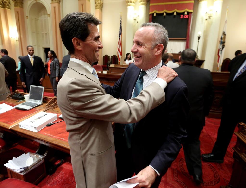 State Sen Mark Leno, D-San Francisco, left, and Senate President Pro Tem Darrell Steinberg, D-Sacramento, hug each other after the end of the two-year legislative session in the early hours of Saturday, Aug. 30, 2014 in Sacramento, Calif. Lawmakers worked into the early morning hours and completed their legislative business ahead of the Aug. 31. deadline.Steinberg will be leaving the Senate due to term limits.(AP Photo/Rich Pedroncelli)