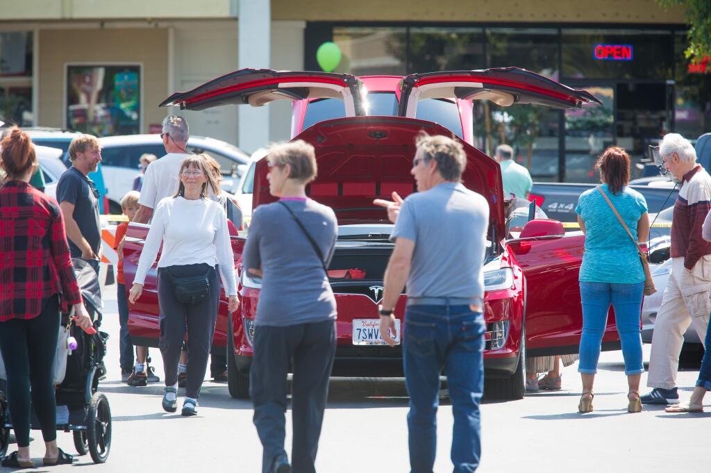 Guests walk around a Tesla Model X during an event promoting electric vehicles at Coddingtown Mall in Santa Rosa, Sunday, Sept. 11, 2016. (Jeremy Portje / For The Press Democrat)