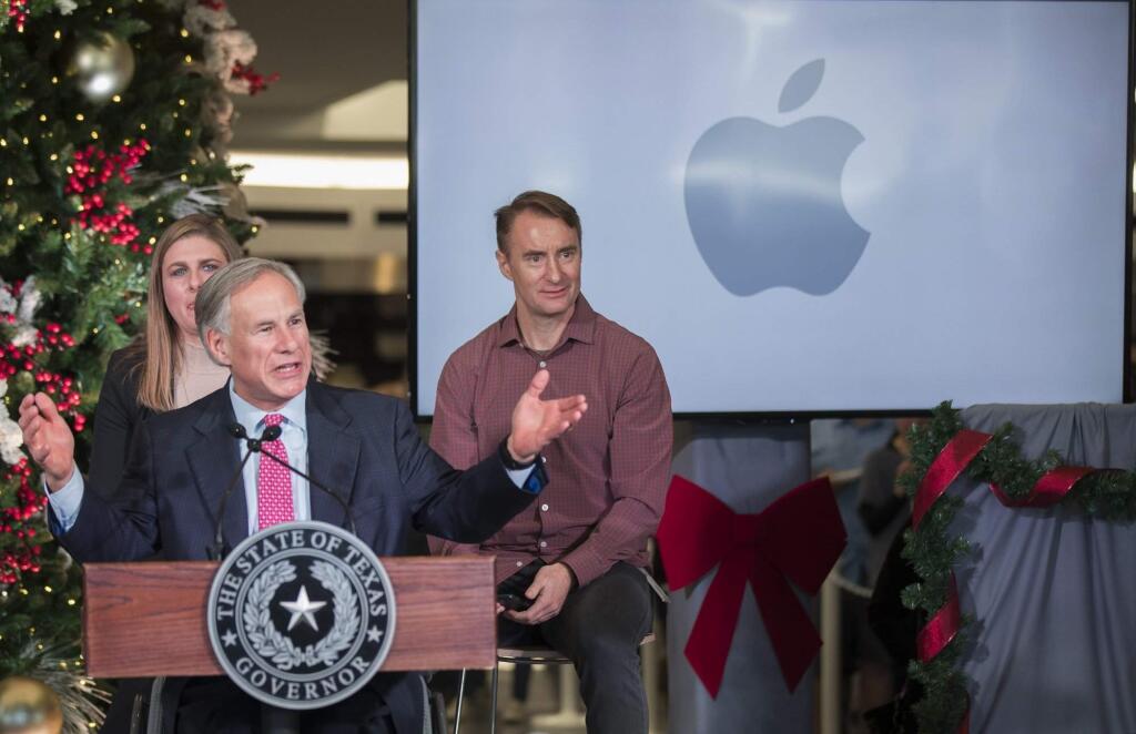 Texas Gov. Greg Abbott speaks about Apple's new campus announcement in Austin, Texas, Thursday, Dec, 13, 2018. Apple plans to build a $1 billion campus in Austin, that will create at least 5,000 jobs ranging from engineers to call-center agents while adding more luster to a Southwestern city that has already become a bustling tech hub. The decision, announced Thursday, comes 11 months after Apple CEO Tim Cook disclosed plans to open a major office outside California on the heels of a massive tax break passed by Congress last year. (Ricardo Brazziell/Austin American-Statesman via AP)